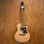 Gilman 12-string acoustic guitar with cutaway and pickup, showing the wooden body, neck, and strings in a natural light setting.