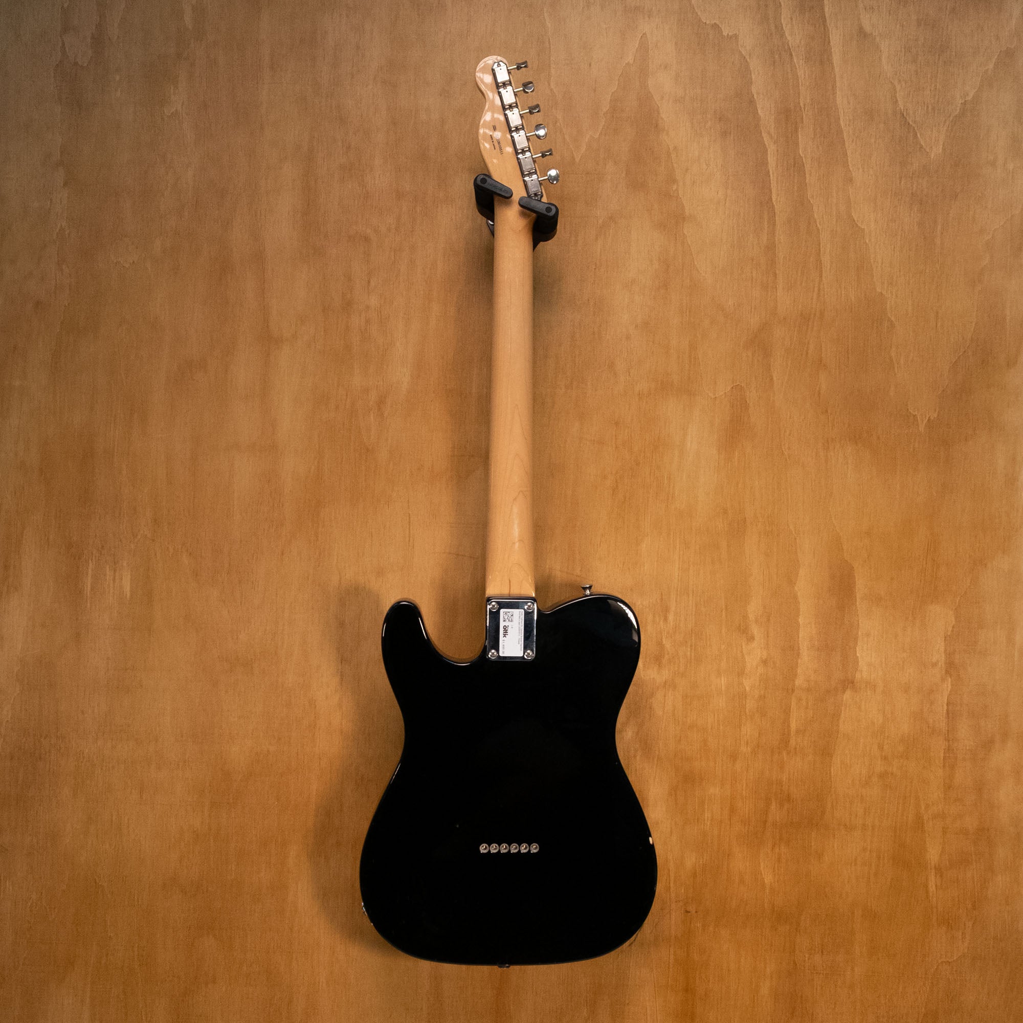 Fender Traditional '60s Telecaster electric guitar with black finish, rosewood fingerboard, made in Japan, shown on a stand.