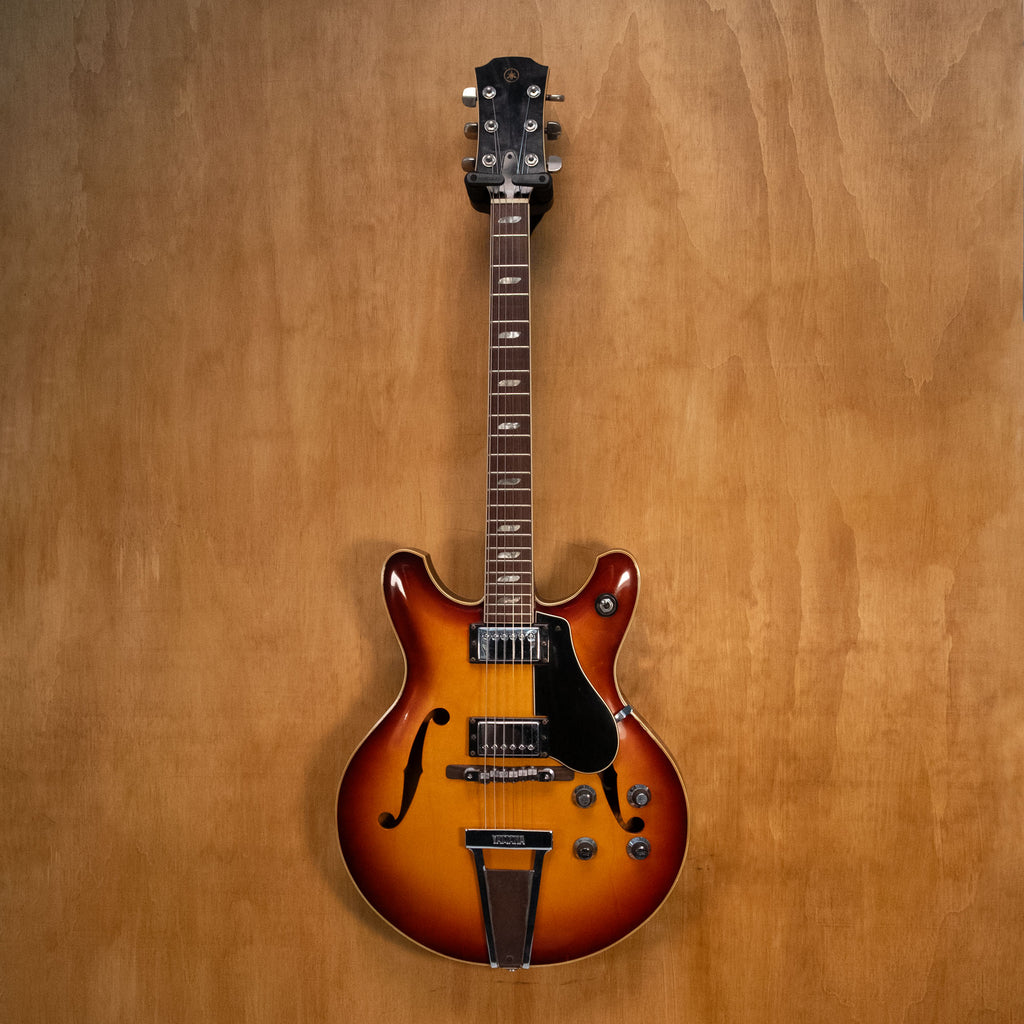 Yamaha SA-60 electric guitar made in Japan, preowned, showing its solid body, neck, and tuning pegs in a close-up shot.