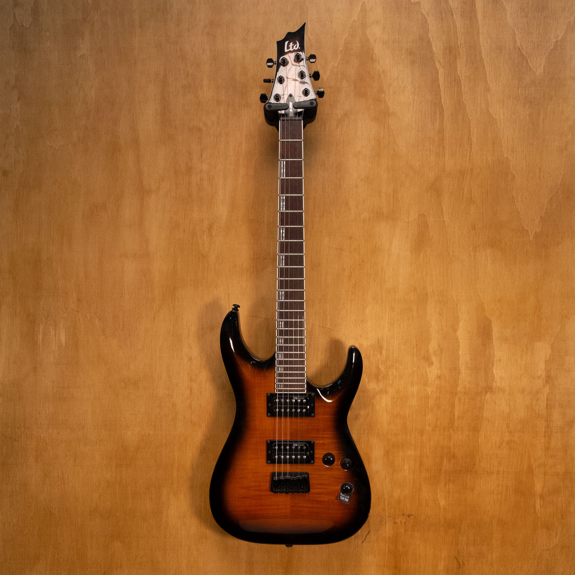ESP LTD H-200 Flame Maple electric guitar in sunburst finish with a sleek body and maple neck, displayed on a plain background.
