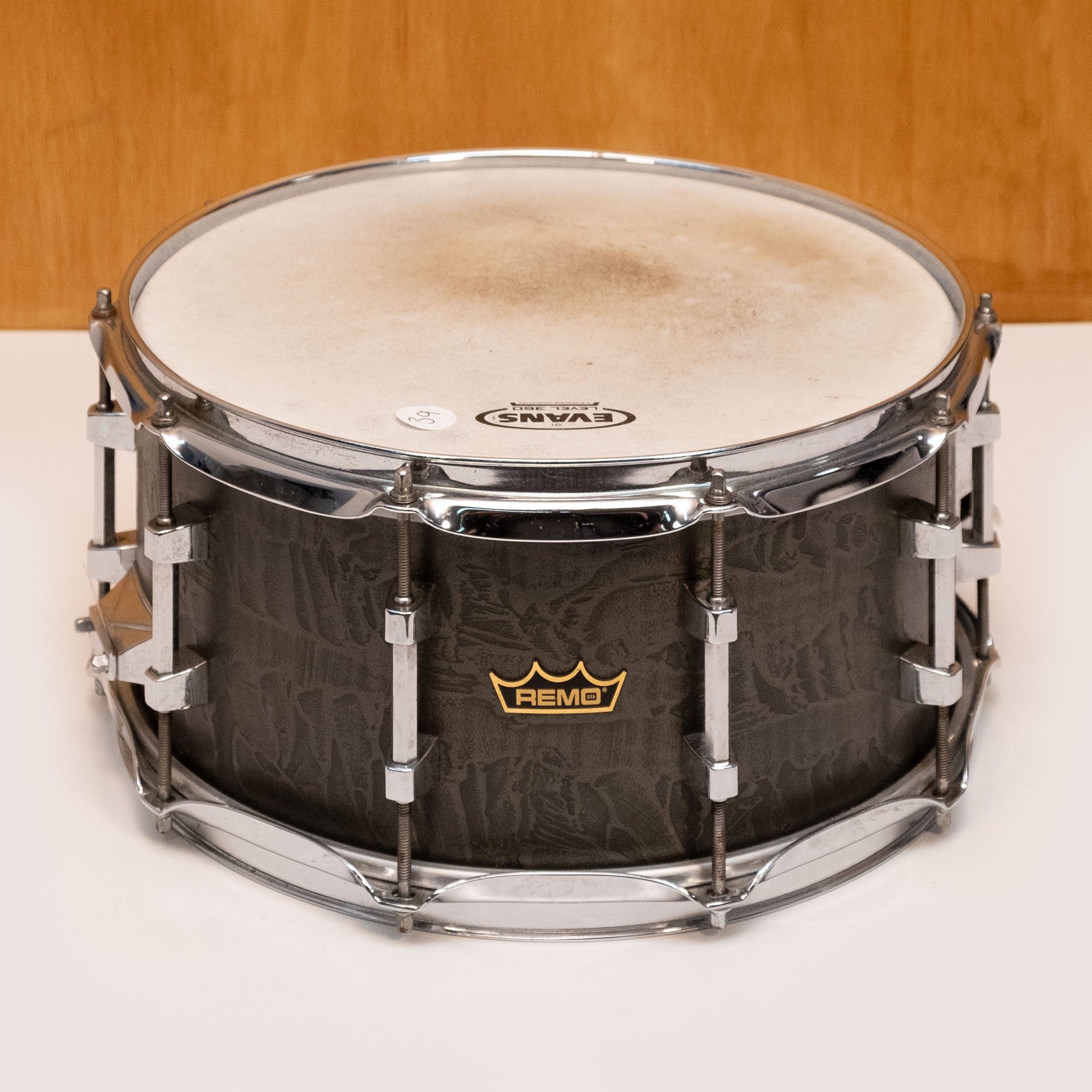 Preloved Remo Gold Crown Advanced Acousticon snare drum with 14-inch diameter and brass wrap, showing the drum's textured surface.