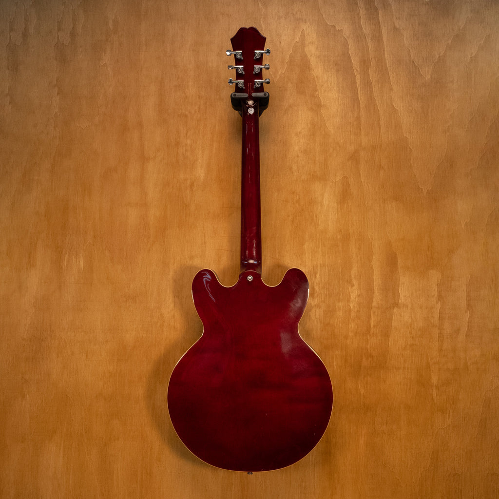Epiphone Noel Gallagher Signature Riviera electric guitar with sunburst finish and chrome hardware, shown on a stand.