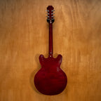 Epiphone Noel Gallagher Signature Riviera electric guitar with sunburst finish and chrome hardware, shown on a stand.