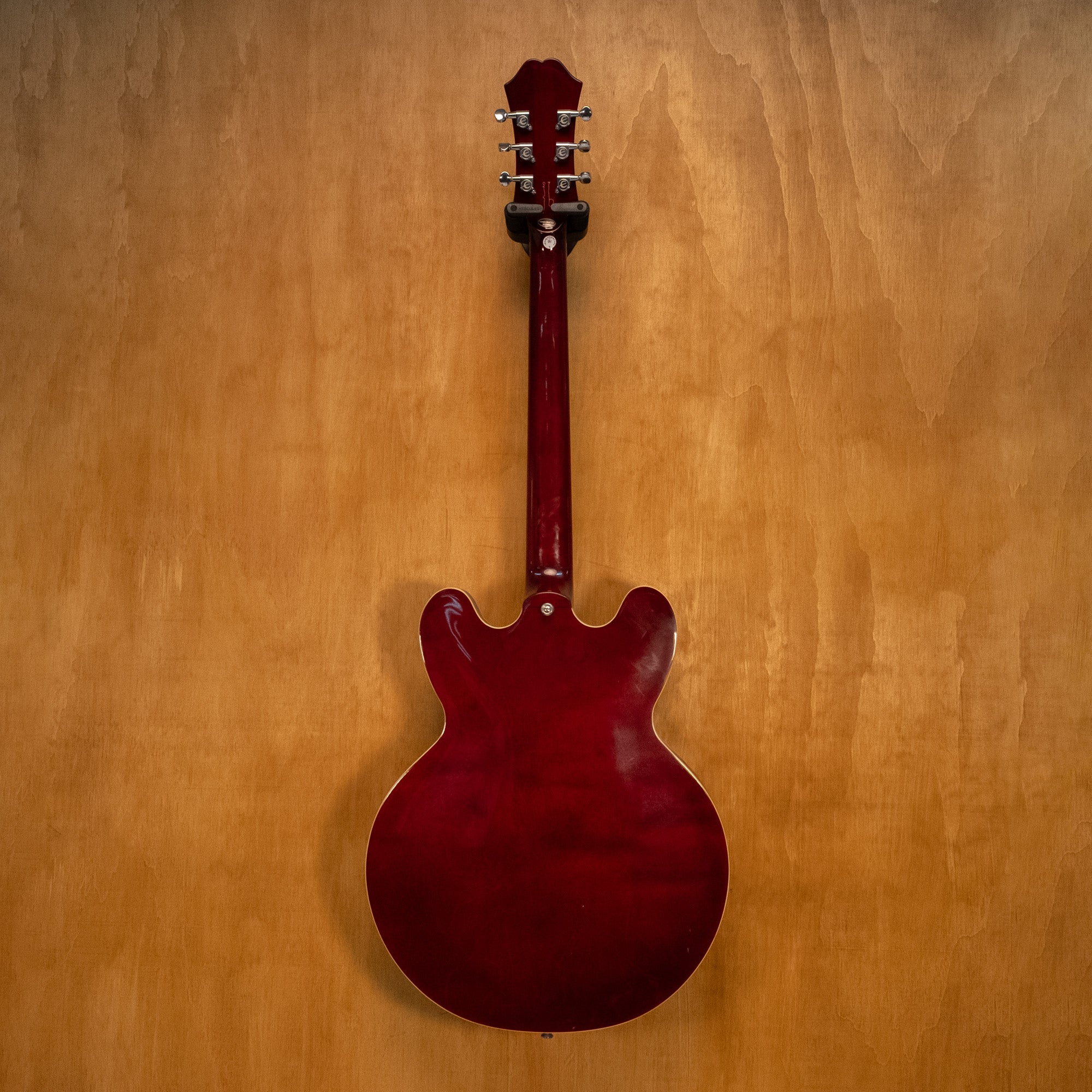 Epiphone Noel Gallagher Signature Riviera electric guitar with sunburst finish and chrome hardware, shown on a stand.