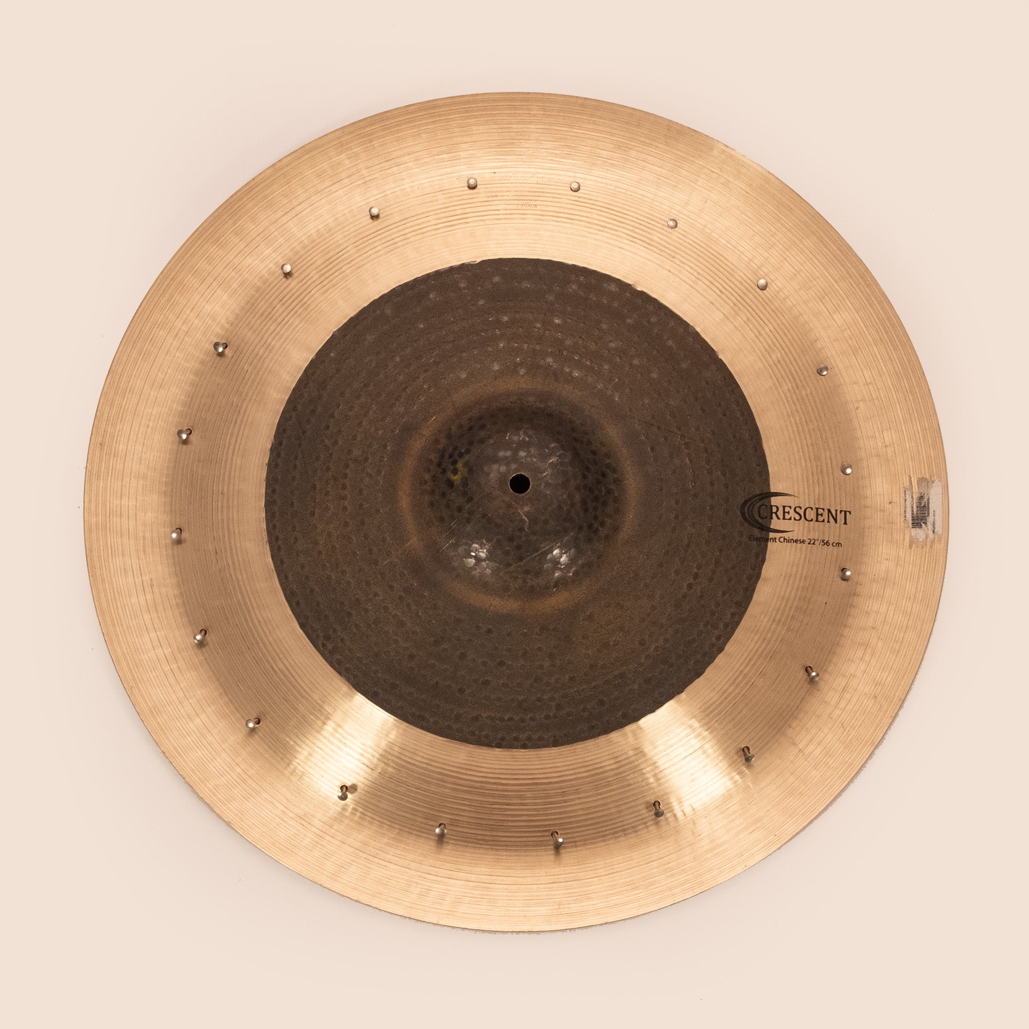 Sabian Crescent 22-inch Element Chinese cymbal with rivets, showing its textured surface and hammered finish in a close-up image.