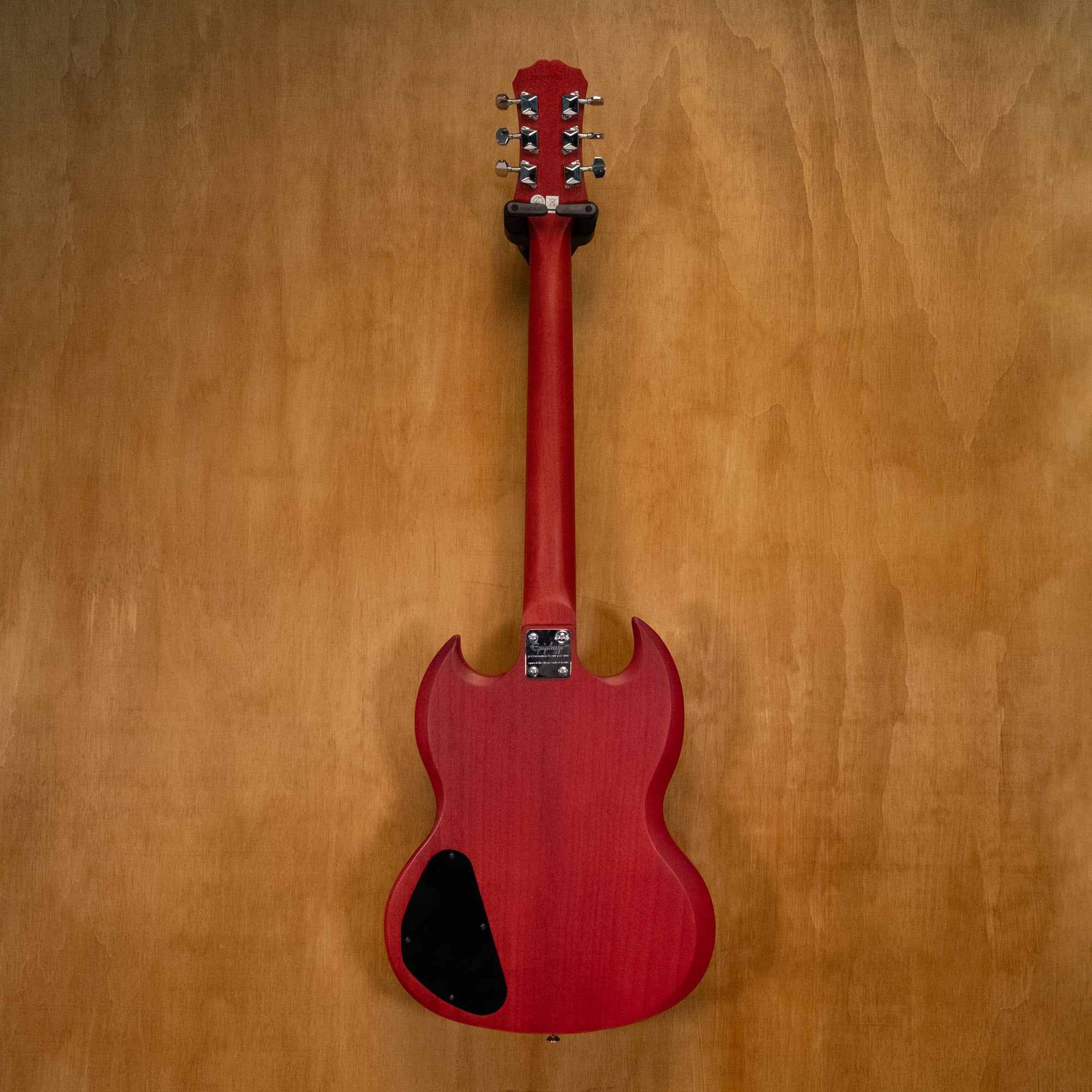 Epiphone SG electric guitar in Worn Cherry finish with black pickguard and dual humbucker pickups, displayed on a stand.