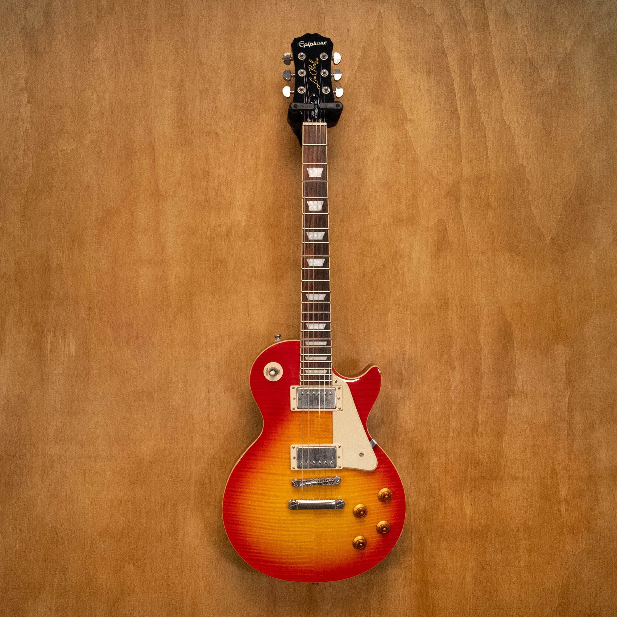 Epiphone Les Paul Standard Plus Top Pro electric guitar in Heritage Cherry Sunburst finish, showcasing its carved maple top and dual humbuckers.