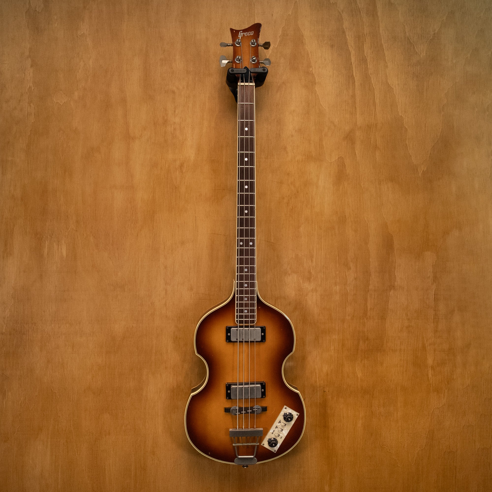 Greco VB-500 Violin Bass Guitar made in Japan, vintage 1983, with a natural wood finish and four strings, close-up view.