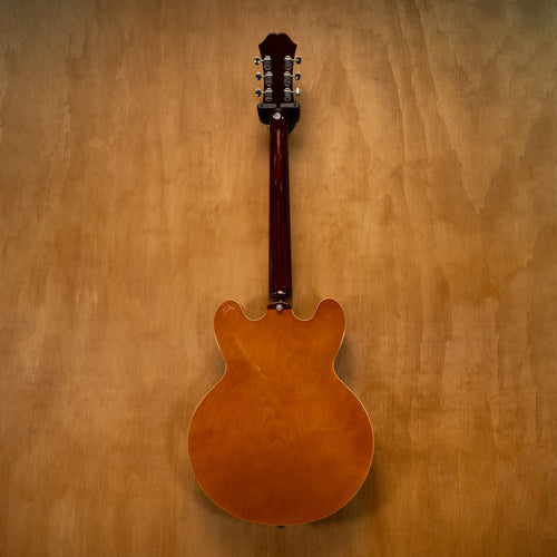 Epiphone Riviera E-360TD electric guitar in royal tan finish, showing the body, pickguard, and neck detail.