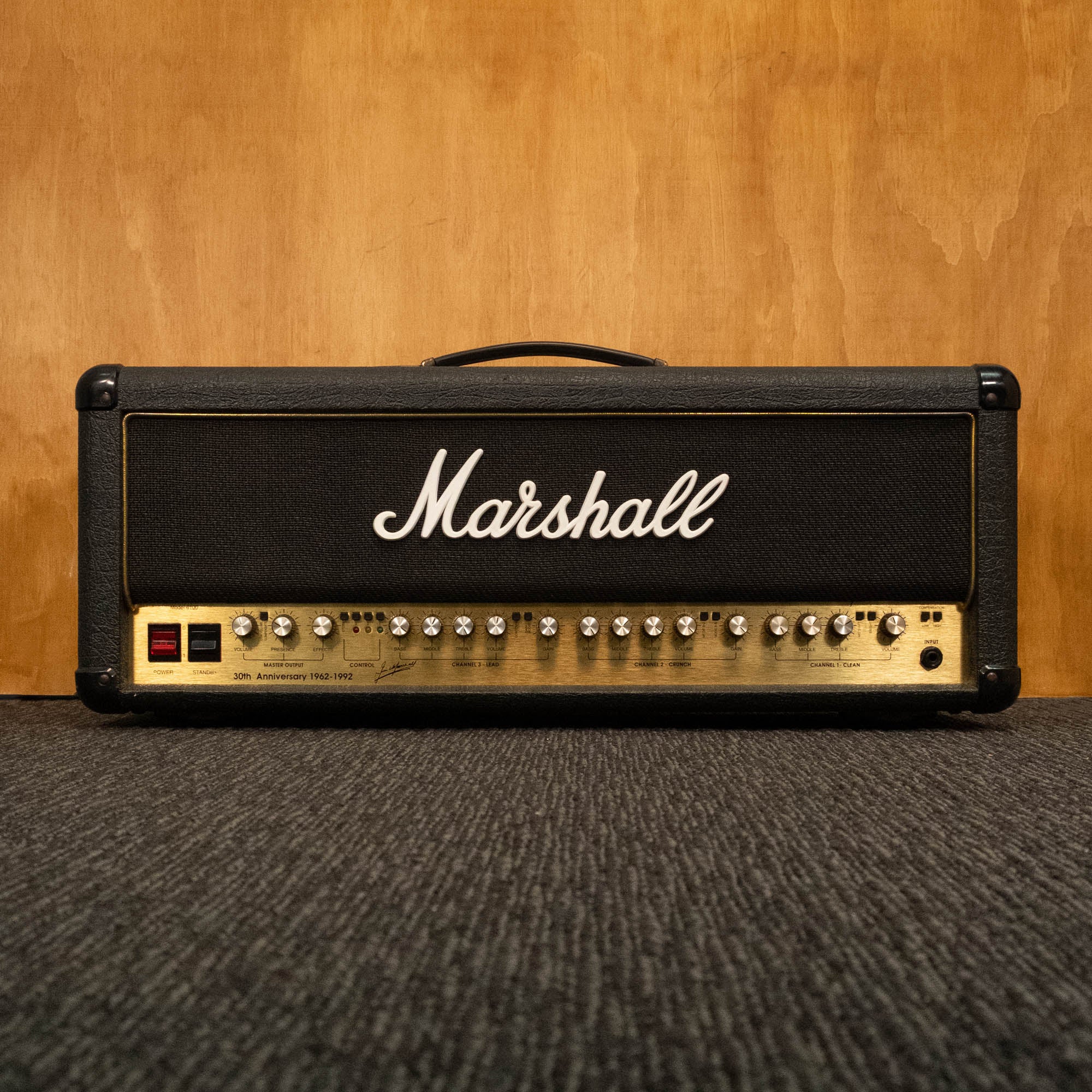 Marshall 6100 30th Anniversary Series 3-channel 100W guitar amplifier head with control knobs and vintage design.