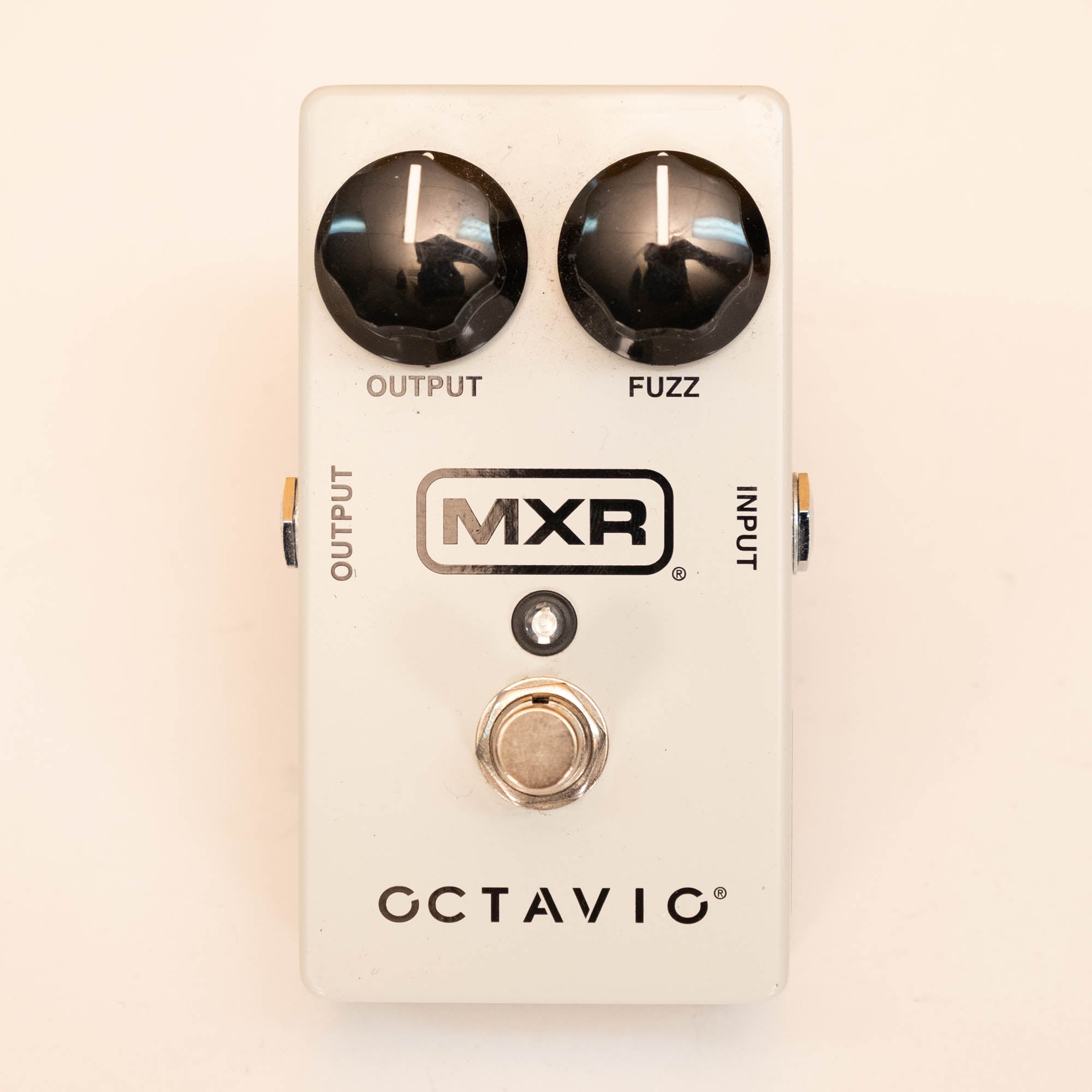MXR M267 Octavio Fuzz guitar effects pedal showing controls and input/output jacks on a pedalboard setup.