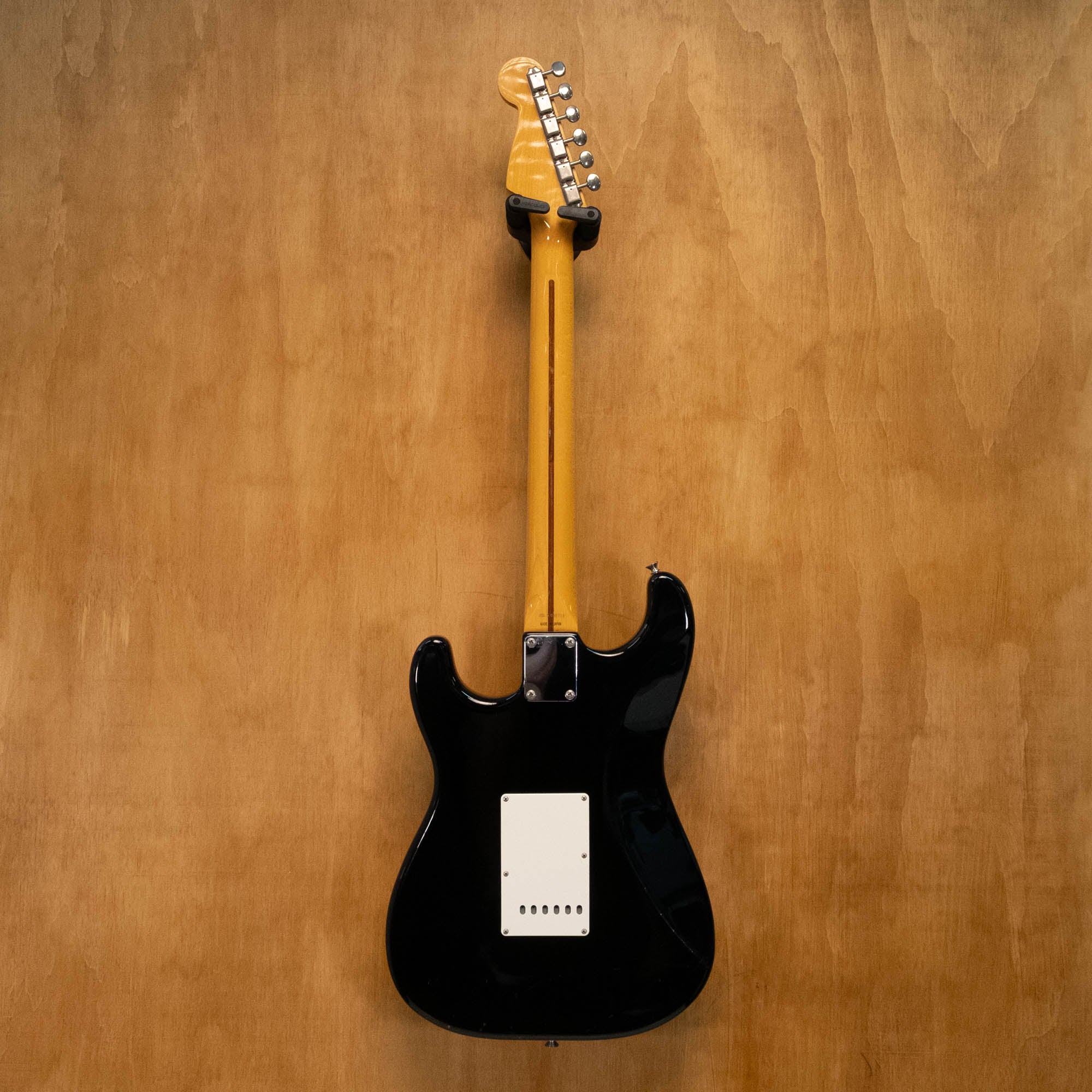 Fender '57 Stratocaster electric guitar in black, made in Japan, vintage-style with maple neck and three single-coil pickups.