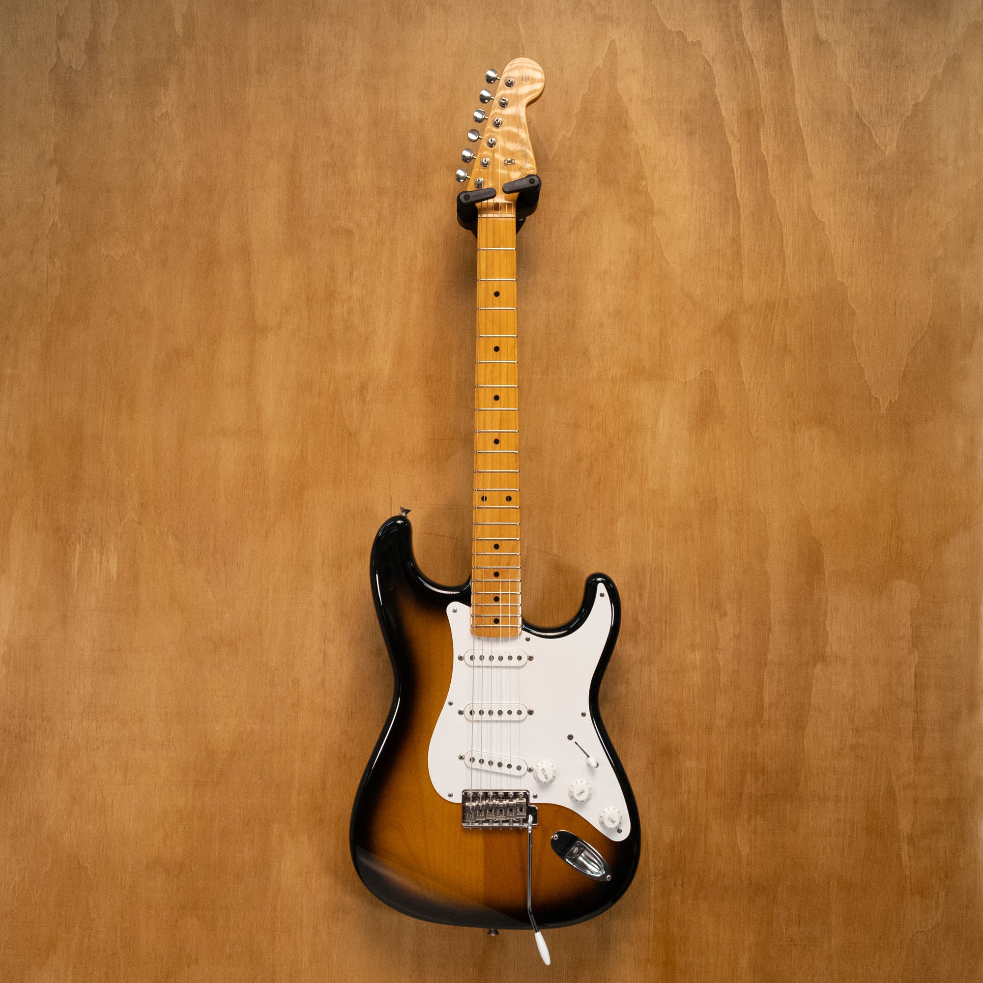Fender '57 Stratocaster electric guitar in 2-tone sunburst with Texas Specials pickups, made in Japan, shown on stand.