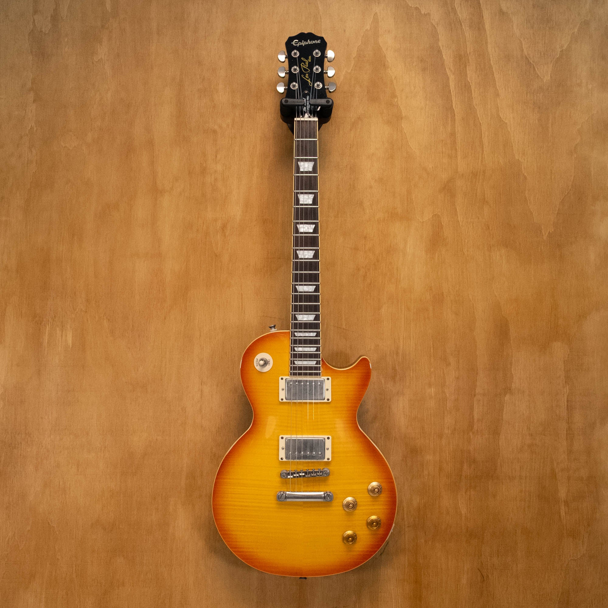 Epiphone Les Paul Standard Plus Top Pro electric guitar in honey burst finish, showing the body, pickups, and neck detail.