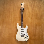 Fender '72 Stratocaster electric guitar with scalloped fingerboard in Olympic White, made in Japan, vintage style, preowned.