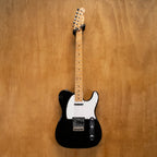 Fender '70s Telecaster TL71 electric guitar in black with maple neck, made in Japan, shown on a stand against a plain background.