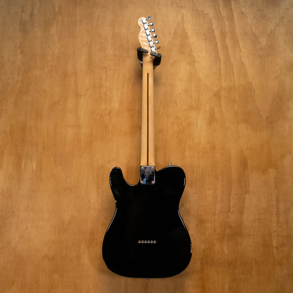 Fender '70s Telecaster TL71 electric guitar in black with maple neck, made in Japan, shown on a stand against a plain background.