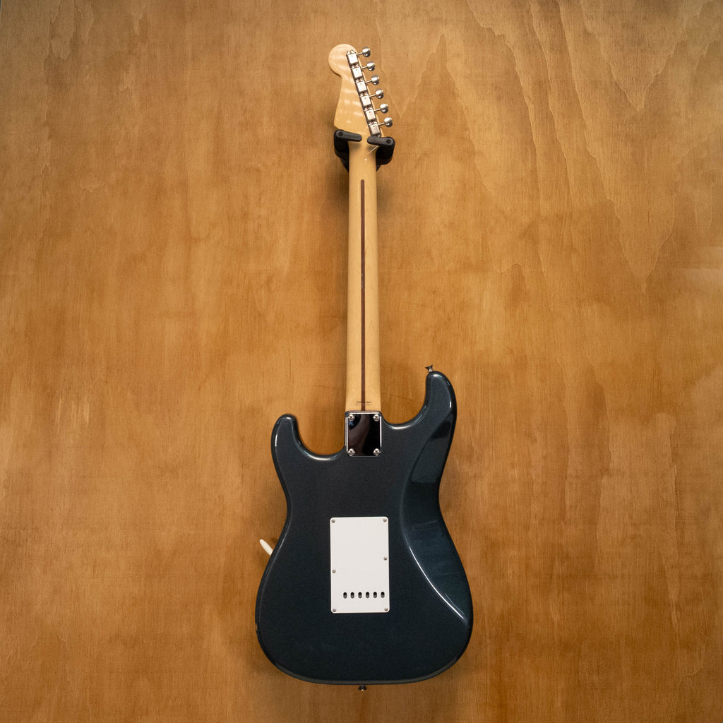 Fender '57 Stratocaster electric guitar in gunmetal blue with Texas Specials, made in Japan, shown on a stand.