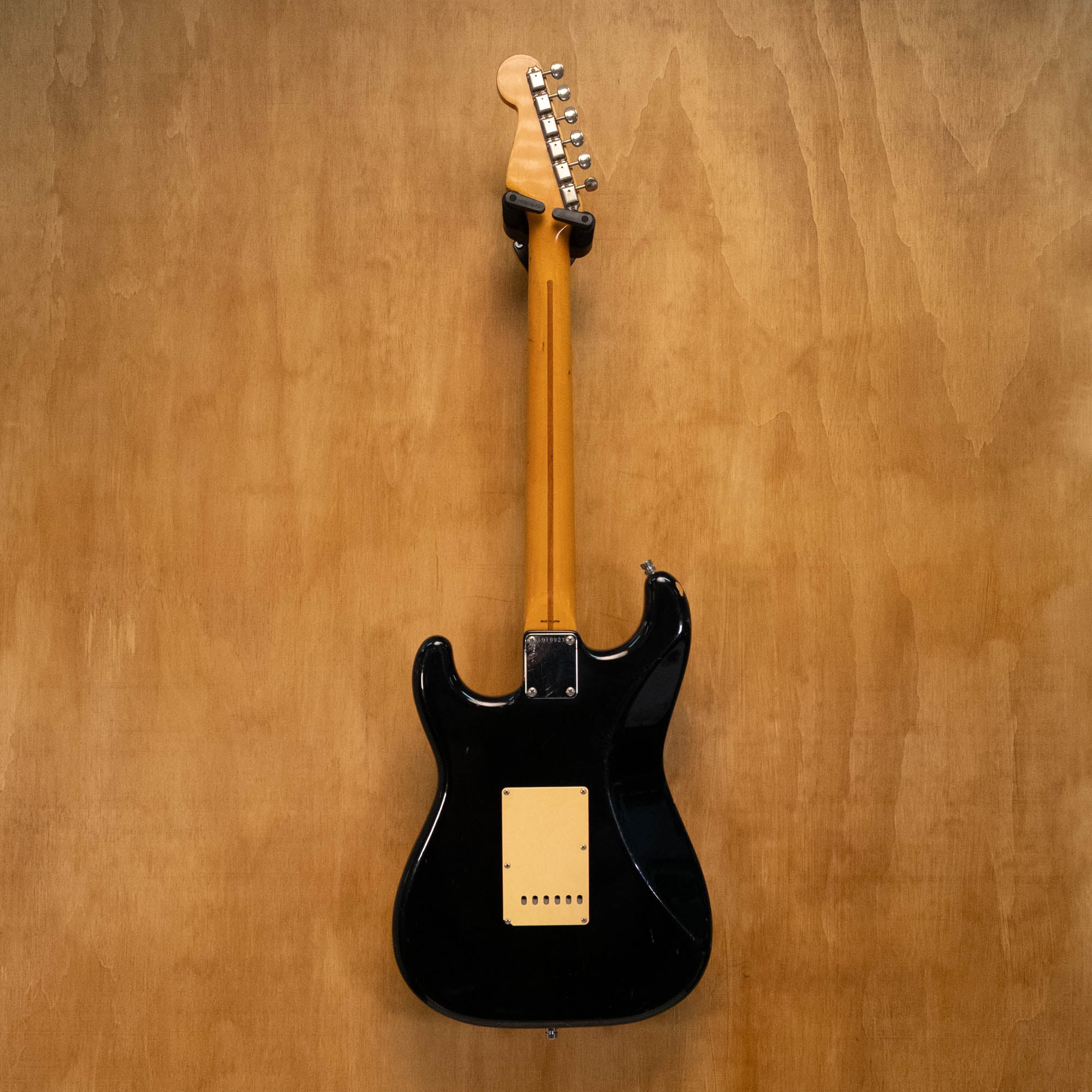 Fender '57 Stratocaster electric guitar in black, made in Japan in 1985, shown with its body and neck details.