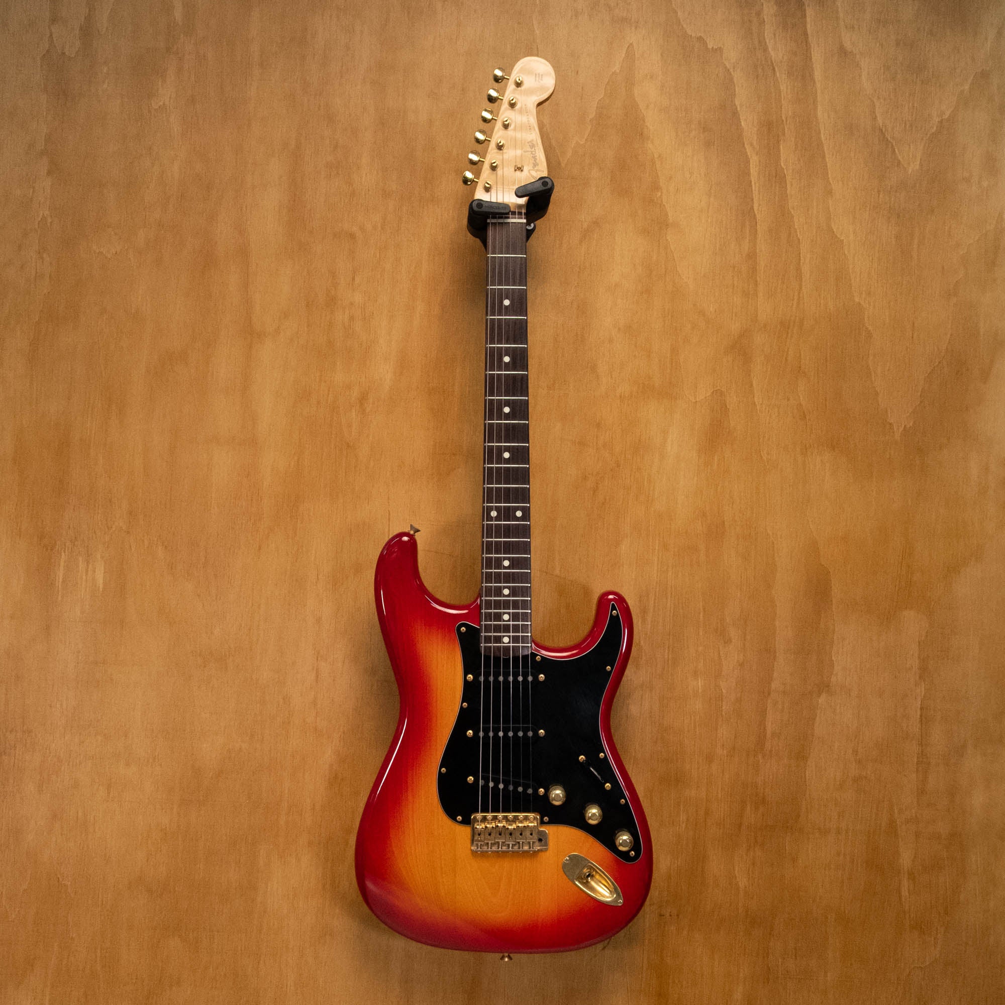 Fender '62 Stratocaster electric guitar in cherry burst finish, made in Japan, with vintage-style body and maple neck.