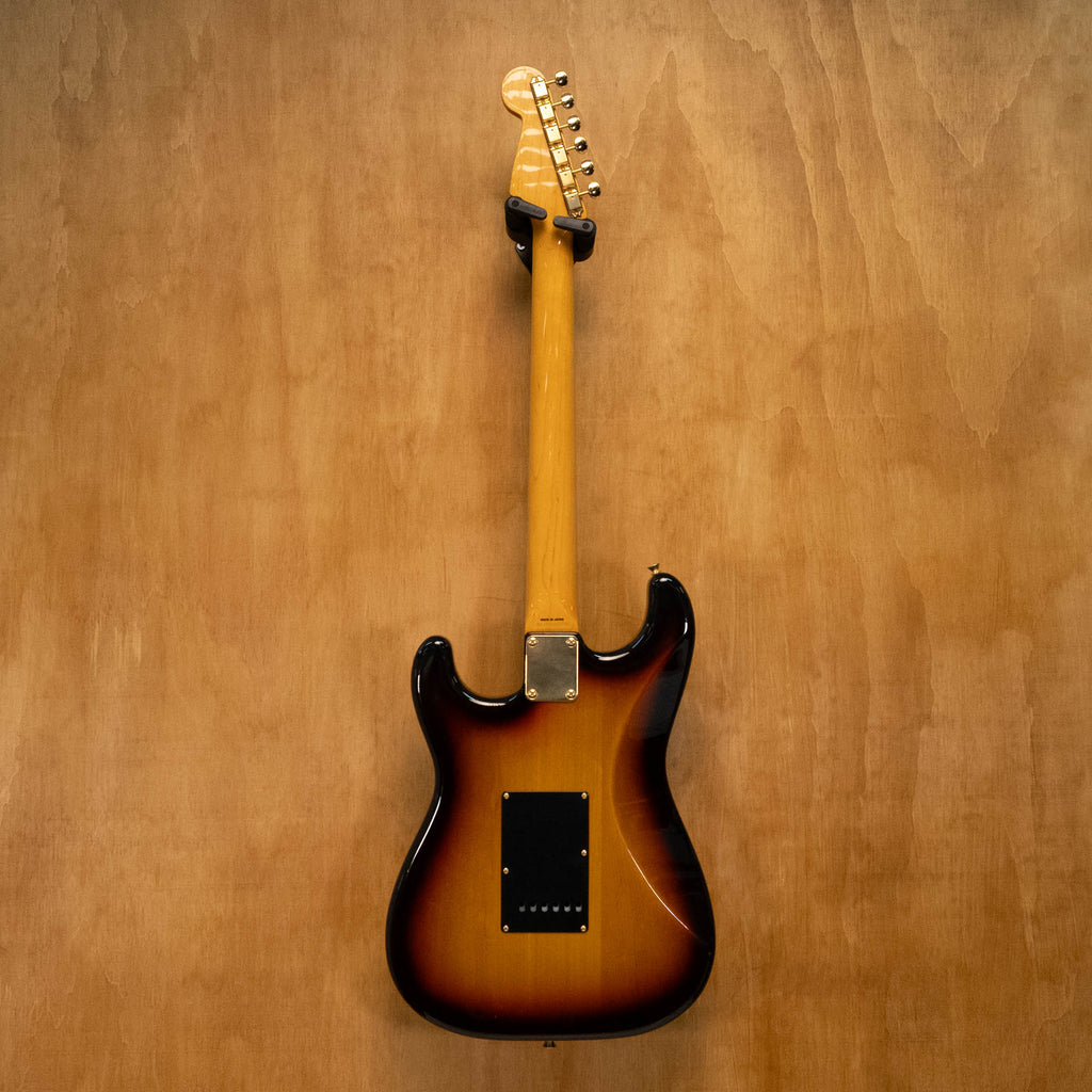 Fender '62 Stratocaster electric guitar in 3-tone sunburst finish with gold hardware, made in Japan, shown in close-up image.