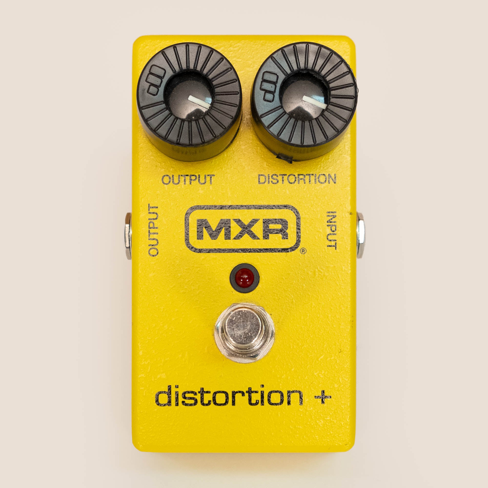 MXR M104 Distortion+ guitar effects pedal, preowned, showing the compact black pedal with control knobs and input/output jacks