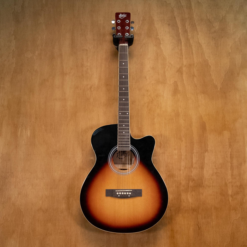 Huxley acoustic guitar in sunburst finish, showcasing its body, neck, and strings, on a plain background.