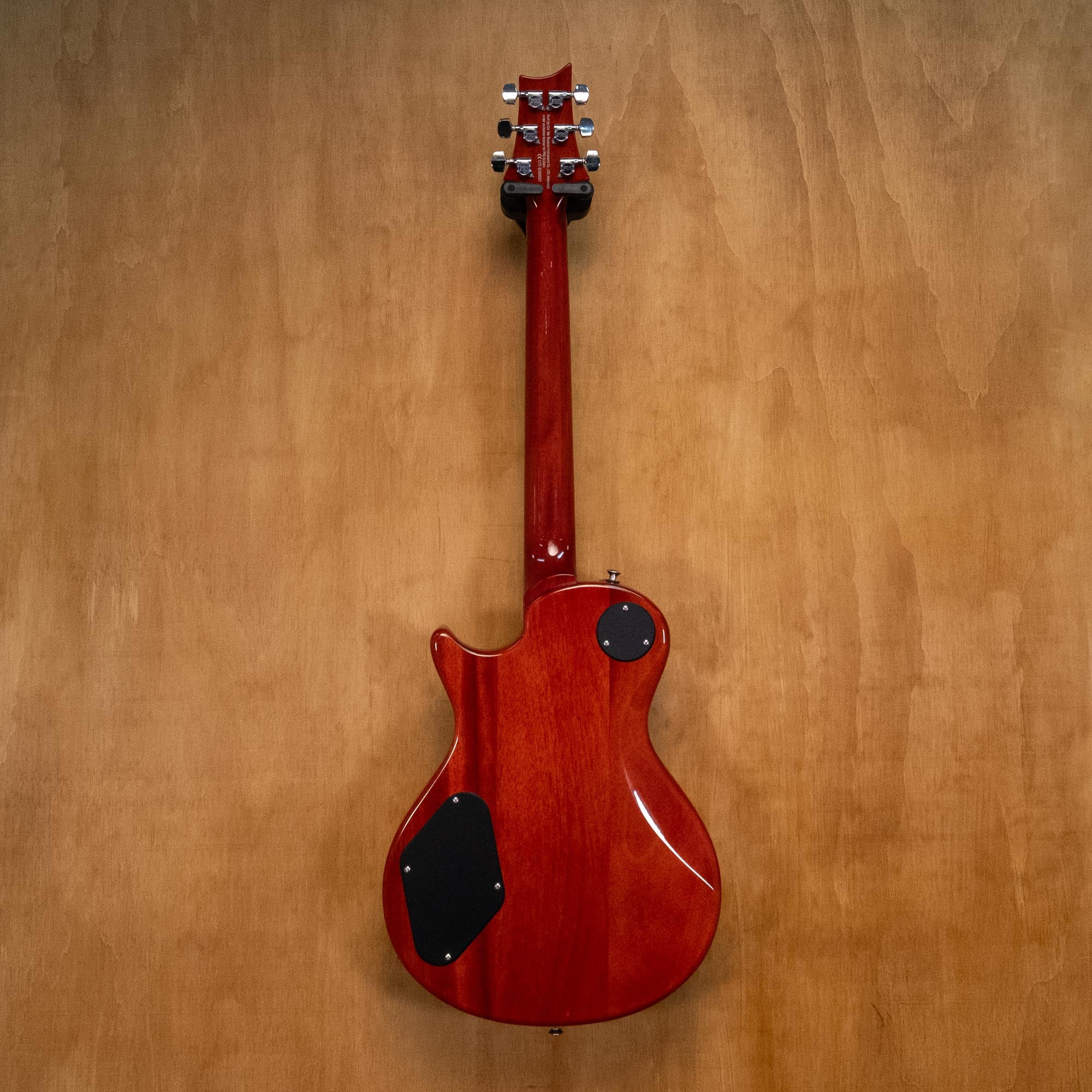 PRS SE 245 single cutaway electric guitar in vintage sunburst finish, showcasing its sleek body and detailed hardware.