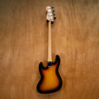 Fender Standard Jazz Bass Guitar in sunburst finish, featuring a sleek body, four strings, and classic design, photographed from the front.