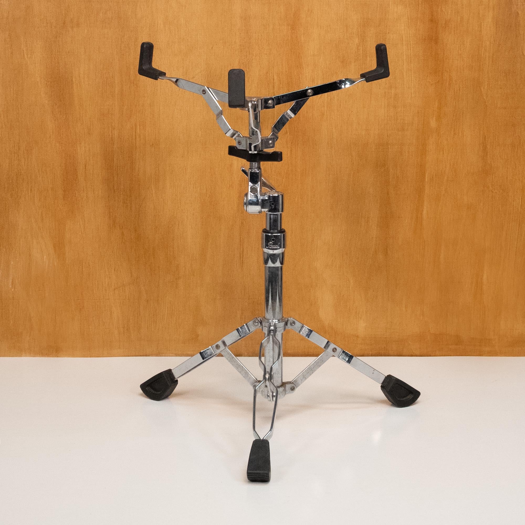 Pearl Pearl Snare Drum Stand for drum hardware and accessories, shown in black with adjustable height and sturdy base.