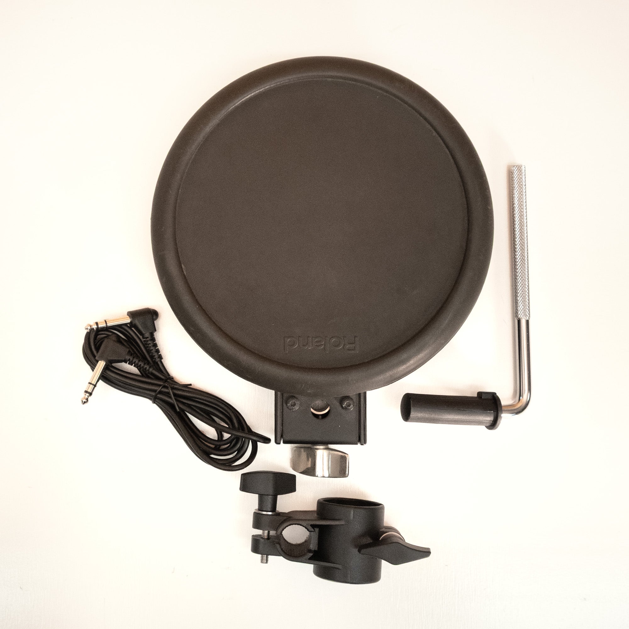 Roland PD-8A electronic drum trigger pad with rubber surface and control knobs, used for triggering drum sounds in a drum kit.