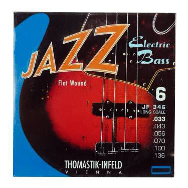 Thomastik JF346 flat wound electric bass guitar string set with six strings, 33-136 gauge, on a neutral background.