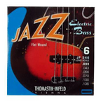 Thomastik JF346 flat wound electric bass guitar string set with six strings, size 33-136, arranged on a display.