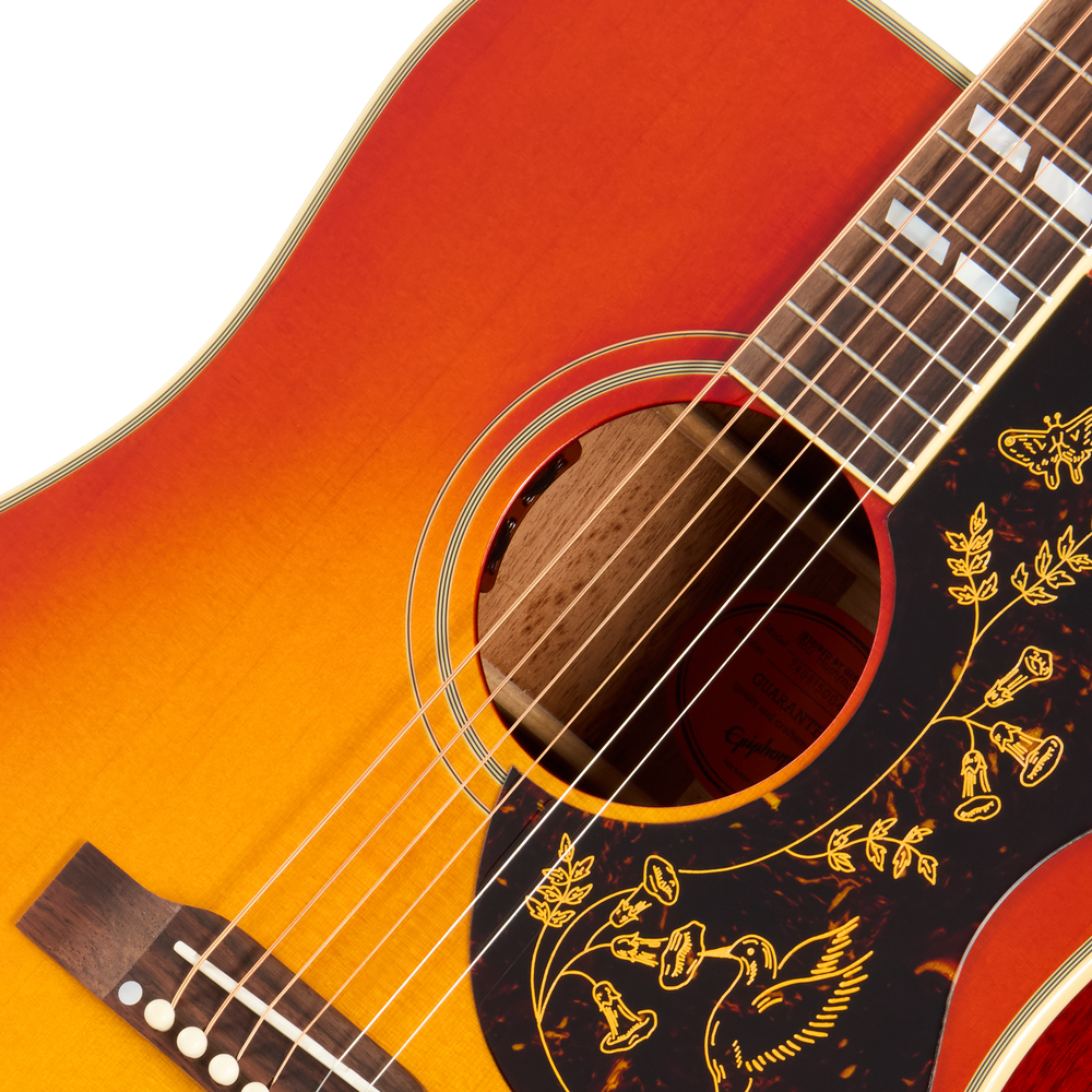 Epiphone 1960 Hummingbird acoustic guitar in Heritage Cherry Sunburst with vintage-style pickguard and detailed woodgrain finish.