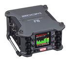 Zoom F6 digital field recorder with multiple input jacks and control knobs, designed for professional audio recording in outdoor settings.
