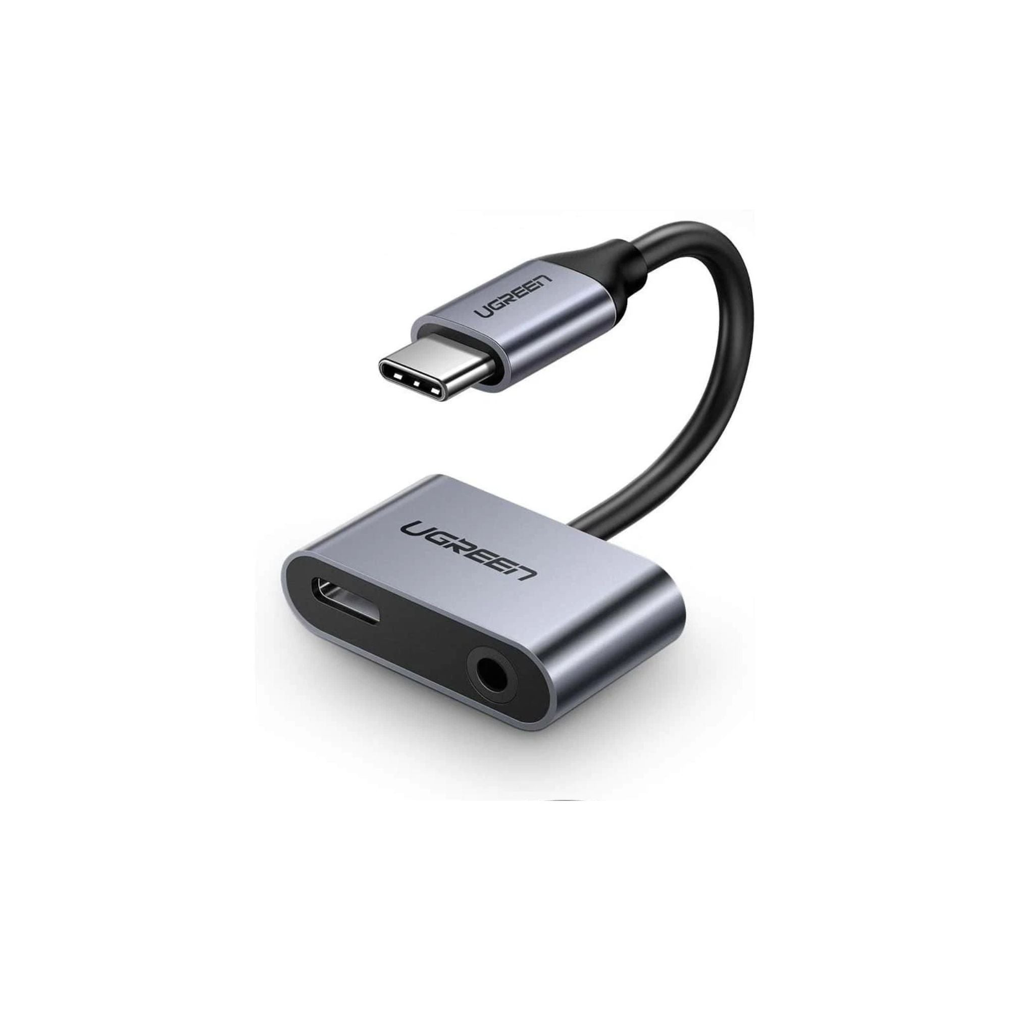 UGREEN USB-C to 3.5mm TRRS headphone and charging adapter connected to a device, compact design for audio and charging.