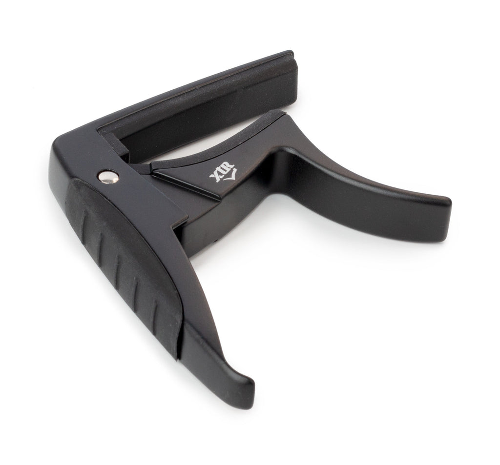 Black XTR Trigger Style Acoustic Guitar Capo clipped onto the neck of a guitar, showing its design and clamp mechanism.