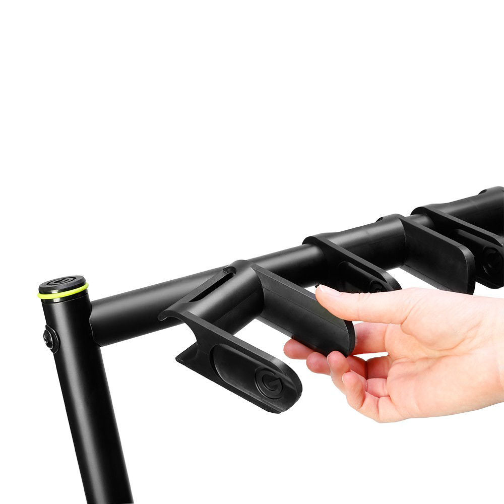 Gravity VARIG7 folding guitar rack holding seven guitars, made of sturdy metal with padded supports for secure display and storage.