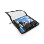 Groovetech Guitar Player Tech Kit with assorted guitar accessories, including tuning pegs, strings, and tools for guitar maintenance.