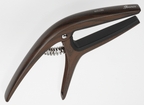 Ibanez ICGC10W wooden finish universal guitar capo attached to a guitar neck, showcasing its smooth wooden surface and adjustable clamp.