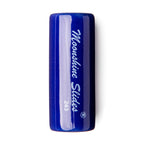 Dunlop Moonshine Slides ceramic medium guitar slide resting on a white surface, showcasing its smooth, rounded shape.
