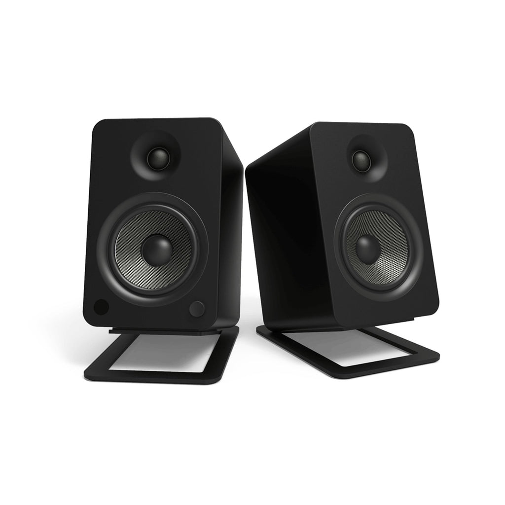 Black Kanto KANS6 large desk top tilted speaker stands for studio monitors, designed to elevate and angle speakers for optimal sound.