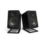 Black Kanto KANS6 large desk top tilted speaker stands for studio monitors, designed to elevate and angle speakers for optimal sound.