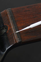 Music Nomad MN106 Tune It Lubricant for guitar tuning pegs and hardware, displayed in a small bottle with a white label.