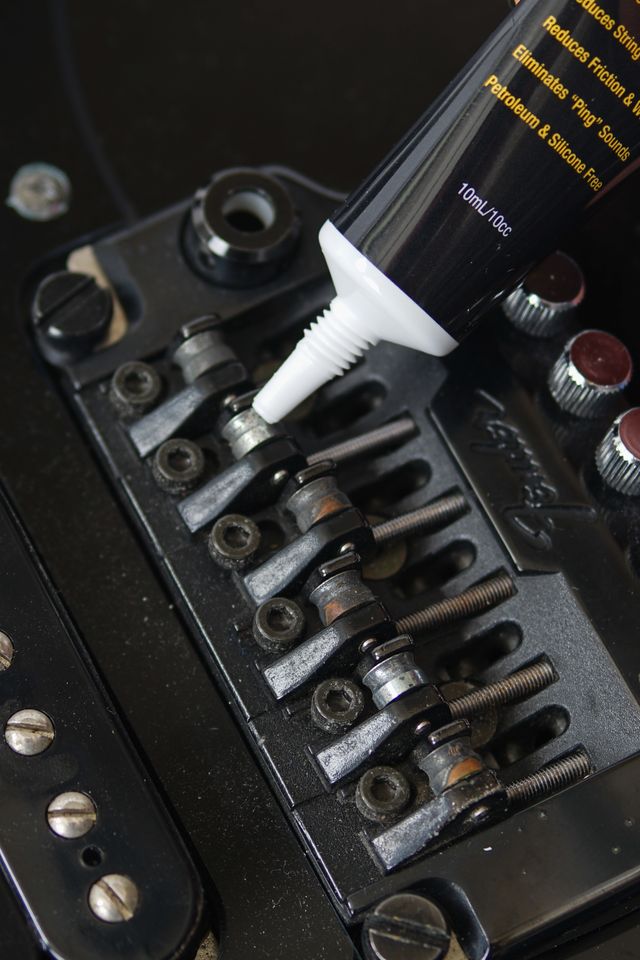 Music Nomad MN106 Tune It lubricant bottle for guitar tuning and maintenance, showing the product label and applicator tip.