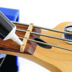 Music Nomad MN106 Tune It lubricant for guitar tuning pegs, in a small bottle with a black cap, used for guitar maintenance.