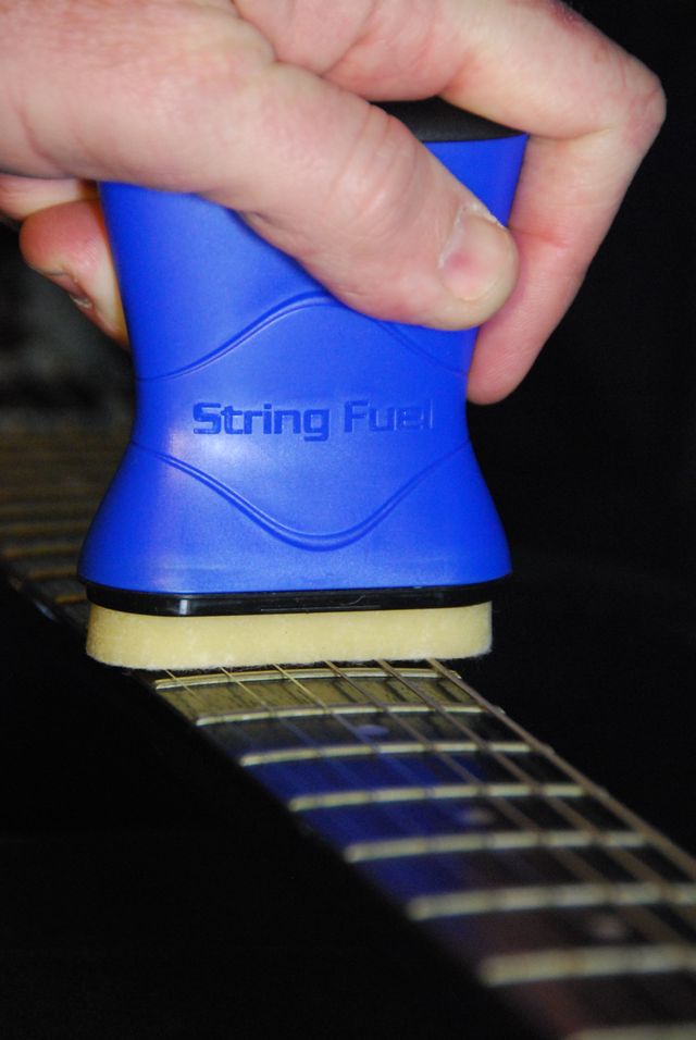 Music Nomad MN109 String Fuel cleaner and lubricant for guitar strings, shown in a compact bottle with a label.