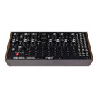 Moog DFAM semi-modular analog percussion synthesizer with drum pads and control knobs on a dark background.