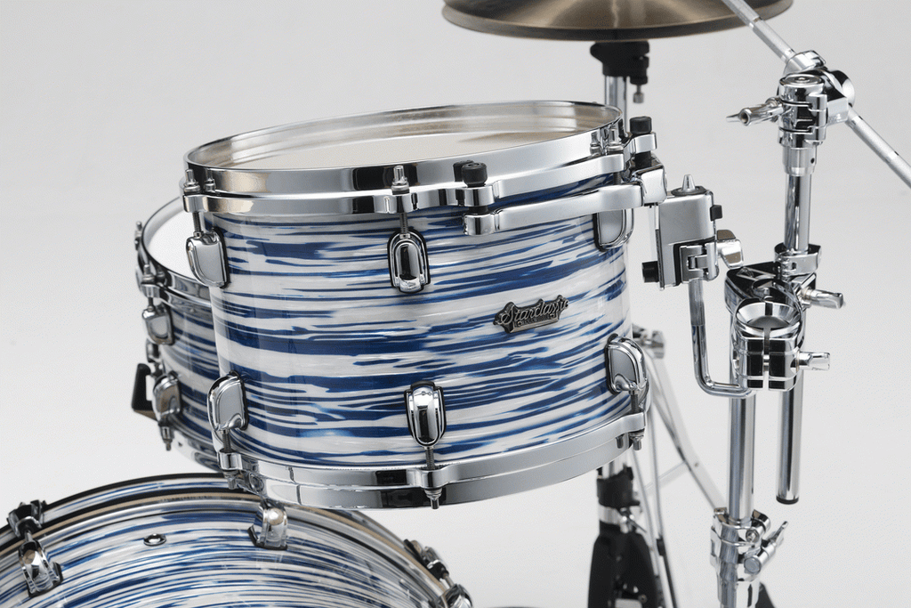 Tama Starclassic Maple 22-inch 3-piece drum kit shell pack with blue and white oyster finish, includes bass, rack, and floor tom drums.
