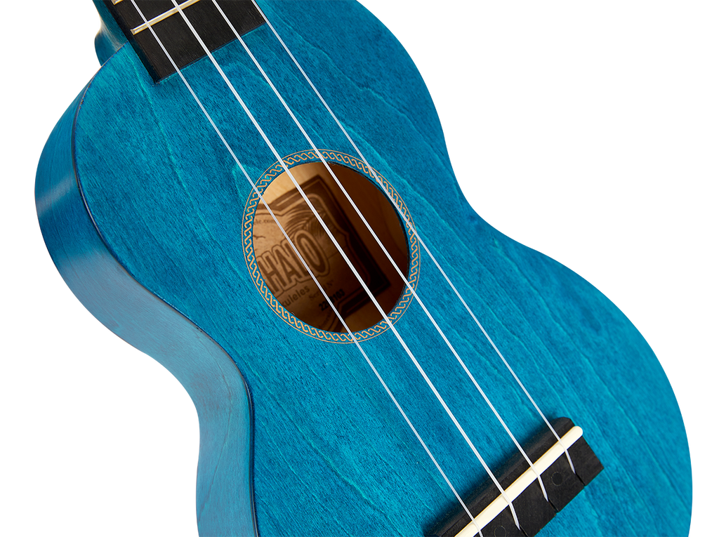 Mahalo MS1TBU Slimline ukulele with transparent blue body, showing the sleek design and wood grain details.